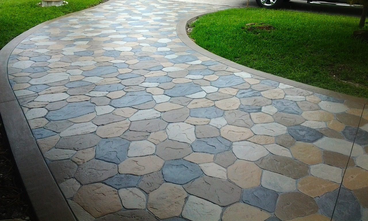 Team applying custom stamped concrete finish to a Weatherford, TX patio for a residential backyard makeover