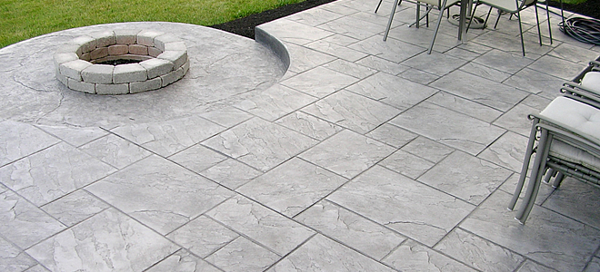 Expert finishing a stamped concrete driveway in Weatherford, TX, demonstrating advanced techniques and attention to local climate needs