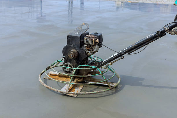 Technician performing concrete polishing on a Weatherford, TX slab with specialized floor-grinding equipment